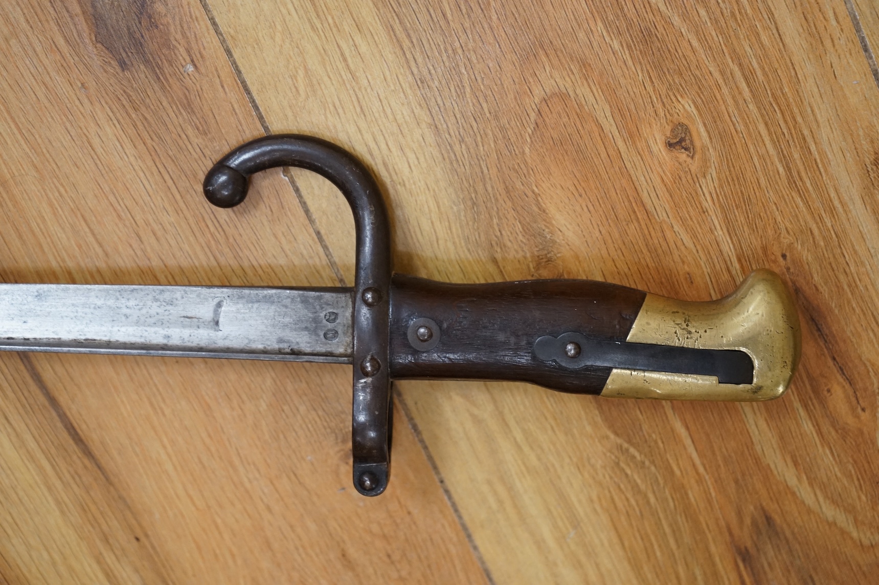 Three bayonets; a gras bayonet, a Lebel bayonet and an Indian Enfield style triangular socket bayonet, all in the original scabbards